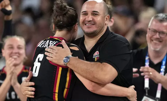 FILE - Belgium head coach Rachid Meziane, center right, hugs Antonia Delaere (6) during a women's quarterfinal game against Spain at Bercy Arena at the 2024 Summer Olympics, Aug. 7, 2024, in Paris, France. (AP Photo/Mark J. Terrill, File)