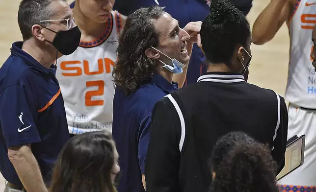 FILE - Connecticut Sun assistant coach Chris Koclanes, center, talks with players during a timeout at a WNBA basketball game against the Washington Mystics, May 28, 2021, in Uncasville, Conn. (Sean D. Elliot/The Day via AP, File) )