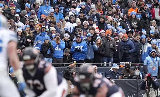 Detroit Lions fans watch their team during the first half of an NFL football game against the Chicago Bears on Sunday, Dec. 22, 2024, in Chicago. (AP Photo/Nam Y. Huh)