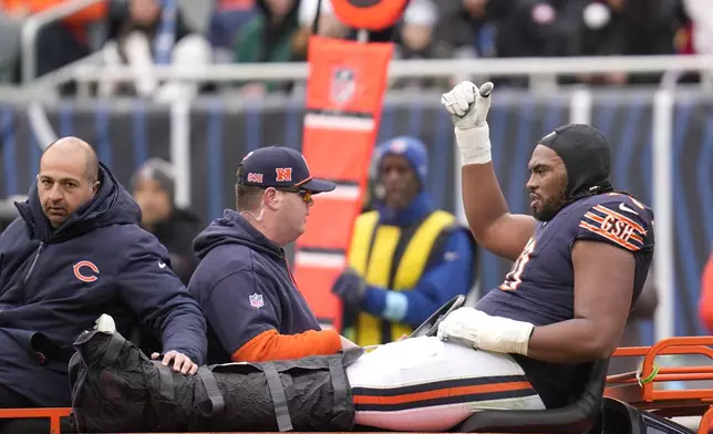 Chicago Bears offensive tackle Braxton Jones gives the thumbs up sign as he is carted off the field during the first half of an NFL football game against the Detroit Lions on Sunday, Dec. 22, 2024, in Chicago. (AP Photo/Erin Hooley)