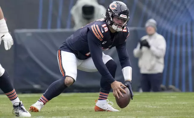 Chicago Bears quarterback Caleb Williams recovers a bad snap from center during the first half of an NFL football game against the Detroit Lions on Sunday, Dec. 22, 2024, in Chicago. (AP Photo/Nam Y. Huh)