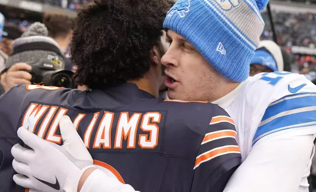 Chicago Bears quarterback Caleb Williams listens to Detroit Lions quarterback Jared Goff after an NFL football game Sunday, Dec. 22, 2024, in Chicago. (AP Photo/Erin Hooley)