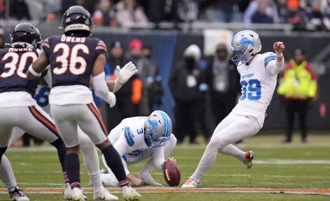 Detroit Lions place kicker Jake Bates steps into a 65-yard field goal attempt off the hold of Jack Fox, that missed right during the first half of an NFL football game against the Chicago Bears on Sunday, Dec. 22, 2024, in Chicago. (AP Photo/Erin Hooley)