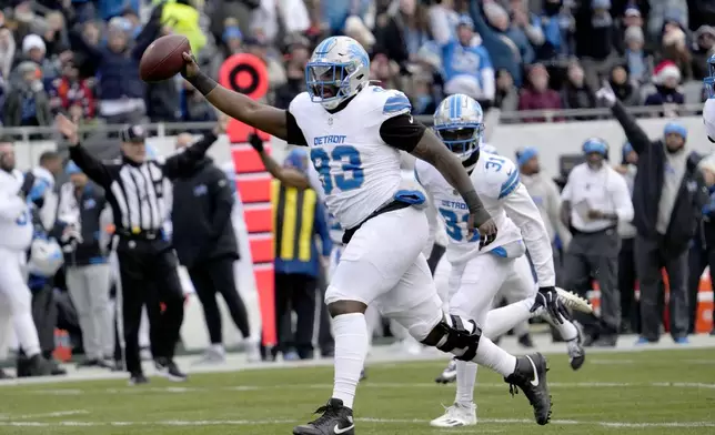 Detroit Lions defensive end Josh Paschal celebrate his recovery of a Chicago Bears fumble during the first half of an NFL football game Sunday, Dec. 22, 2024, in Chicago. (AP Photo/Nam Y. Huh)