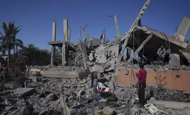 Palestinians check the rubble of a destroyed building following an overnight Israeli strike in Deir al-Balah, Gaza Strip, Wednesday, Dec. 4, 2024. (AP Photo/Abdel Kareem Hana)