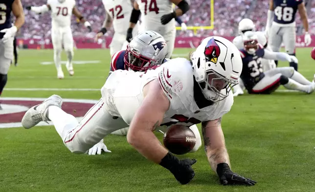 Arizona Cardinals offensive tackle Jonah Williams recovers a fumble for a touchdown against the New England Patriots during the first half of an NFL football game, Sunday, Dec. 15, 2024, in Glendale, Ariz. (AP Photo/Rick Scuteri)