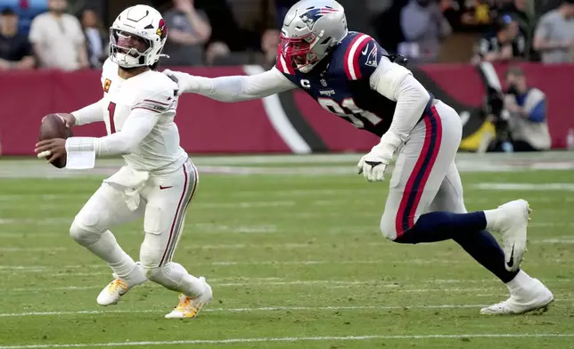 Arizona Cardinals quarterback Kyler Murray (1) is sacked by New England Patriots defensive end Deatrich Wise Jr., right, during the second half of an NFL football game, Sunday, Dec. 15, 2024, in Glendale, Ariz. (AP Photo/Rick Scuteri)