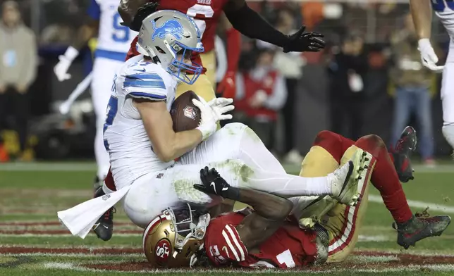 Detroit Lions tight end Sam LaPorta (87) catches a touchdown over San Francisco 49ers cornerback Isaac Yiadom (22) during the second half of an NFL football game Monday, Dec. 30, 2024, in Santa Clara, Calif. (AP Photo/Jed Jacobsohn)