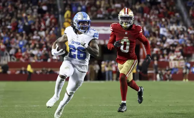 Detroit Lions running back Jahmyr Gibbs (26) scores a rushing touchdown past San Francisco 49ers cornerback Renardo Green (0) during the second half of an NFL football game Monday, Dec. 30, 2024, in Santa Clara, Calif. (AP Photo/Jed Jacobsohn)