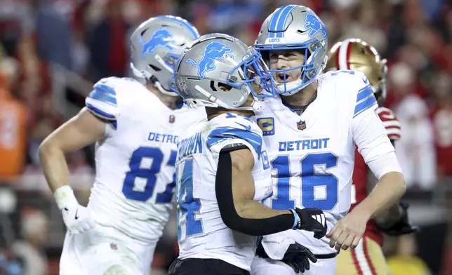 Detroit Lions quarterback Jared Goff (16) celebrates after throwing a touchdown pass to wide receiver Amon-Ra St. Brown (14) during the second half of an NFL football game against the San Francisco 49ers, Monday, Dec. 30, 2024, in Santa Clara, Calif. (AP Photo/Jed Jacobsohn)