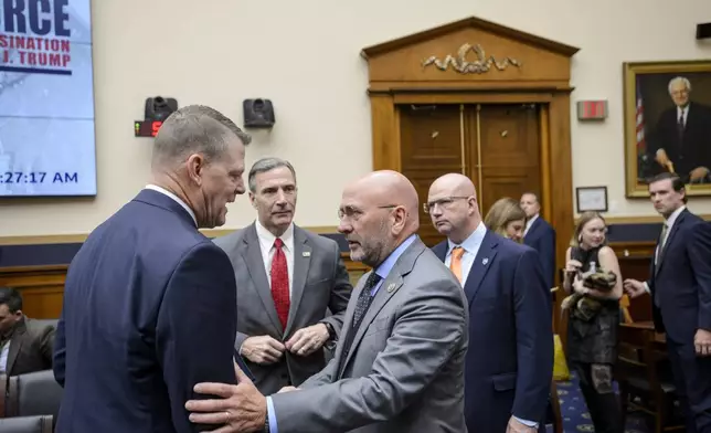 Secret Service Acting Director Ronald L. Rowe Jr., left, talks with Rep. Clay Higgins, R-La., following a hearing by the House Task Force on the Attempted Assassination of Donald J. Trump on the Secret Service's security failures regarding the assassination attempts on President-elect Trump, in Butler, Pa., July 13, 2024, and West Palm Beach, Fla., Sept. 15, 2024, on Capitol Hill, Thursday, Dec. 5, 2024, in Washington. (AP Photo/Rod Lamkey, Jr.)