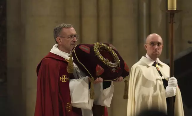 The ancient relic that many Christians revere as Jesus Christ's "Crown of Thorns" is presented as it is returning to Notre Dame Cathedral, five years after it was saved from the flames of the cathedral's devastating 2019 fire, Friday, Dec. 13, 2024 in Paris. (AP Photo/Aurelien Morissard)