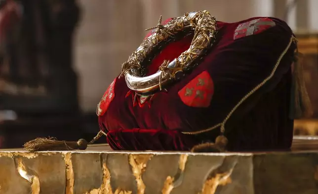 FILE - The crown of thorns relic believed to have been worn by Jesus Christ is displayed on the altar during a Good Friday veneration at the St Germain l'Auxerrois church in Paris, Friday, April 2, 2021. An ancient relic that many Christians revere as Jesus Christ's "Crown of Thorns" is returning to Notre Dame, nearly five years after it was saved from the flames of the cathedral's devastating 2019 fire. (AP Photo/Michel Euler, File)