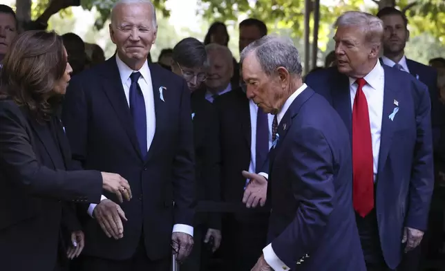 Democratic presidential nominee Vice President Kamala Harris, far left, greets Republican presidential nominee former President Donald Trump, far right, as President Joe Biden and Michael Bloomberg look on upon arriving for the 9/11 Memorial ceremony on the 23rd anniversary of the Sept. 11, 2001 attacks, Wednesday, Sept. 11, 2024, in New York. (AP Photo/Yuki Iwamura)