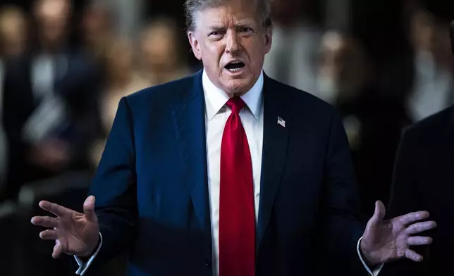 Former President Donald Trump speaks as he arrives at Manhattan criminal court with his legal team ahead of the start of jury selection in New York, Monday, April 15, 2024. (Jabin Botsford/The Washington Post via AP, Pool)