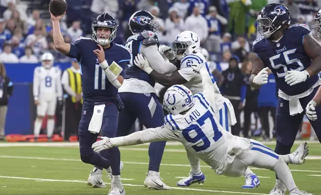 Tennessee Titans quarterback Mason Rudolph (11) throws a pass over Indianapolis Colts defensive end Laiatu Latu (97) during the second half of an NFL football game Sunday, Dec. 22, 2024, in Indianapolis. (AP Photo/Michael Conroy)