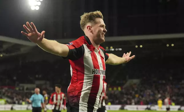 Brentford's Nathan Collins celebrates scoring their side's third goal during the English Premier League soccer match between Brentford and Newcastle United at the Gtech Community Stadium, London, Saturday, Dec. 7, 2024. (Jonathan Brady/PA via AP)