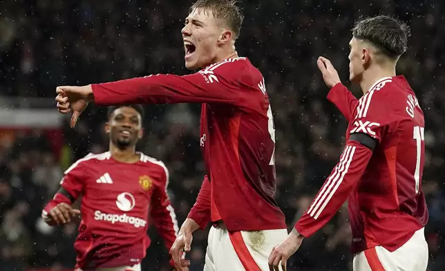 Manchester United's Rasmus Hojlund celebrates scoring his side's first goal during the English Premier League soccer match between Manchester United and Nottingham Forest, at Old Trafford, Manchester, England, Saturday Dec. 7, 2024. (Martin Rickett/PA via AP)