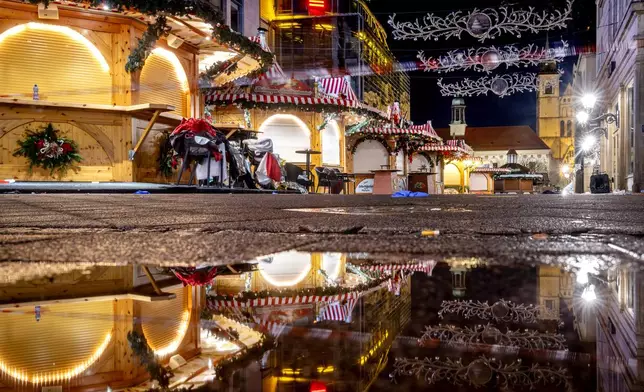 The Christmas market, where a car drove into a crowd on Friday evening, in Magdeburg, Germany, is empty on Sunday morning , Dec. 22, 2024. (AP Photo/Michael Probst)