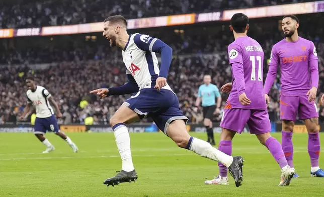 Tottenham Hotspur's Rodrigo Bentancur, front, celebrates after scoring his side's first goal during the English Premier League soccer match between Tottenham Hotspur and Wolverhampton Wanderers in London, England, Sunday, Dec. 29, 2024. (John Walton/PA via AP)