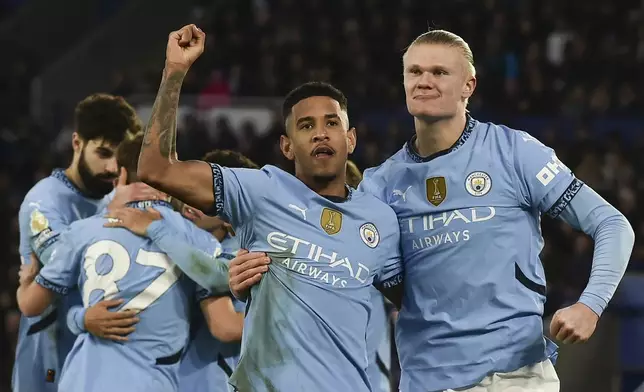 Manchester City's Erling Haaland, right, celebrates with Manchester City's Savinho after scoring his side's second goal during the English Premier League soccer match between Leicester City and Manchester City at King Power stadium in Leicester, England, Sunday, Dec. 29, 2024. (AP Photo/Rui Vieira)