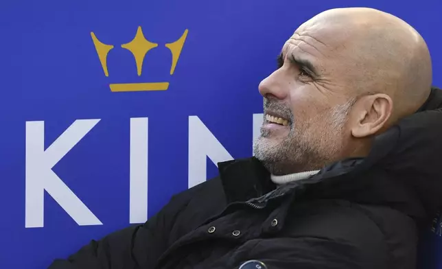 Manchester City's head coach Pep Guardiola looks out from the bench prior the English Premier League soccer match between Leicester City and Manchester City at King Power stadium in Leicester, England, Sunday, Dec. 29, 2024. (AP Photo/Rui Vieira)