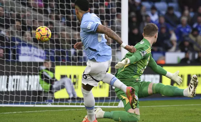 Manchester City's Savinho, left, scores his side's opening goal during the English Premier League soccer match between Leicester City and Manchester City at King Power stadium in Leicester, England, Sunday, Dec. 29, 2024. (AP Photo/Rui Vieira)