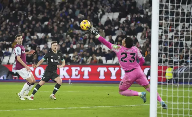 Liverpool's Diogo Jota, center, scores his side's fifth goal during the English Premier League soccer match between West Ham United and Liverpool at the London Stadium in London, Sunday, Dec. 29, 2024. (AP Photo/Kirsty Wigglesworth)