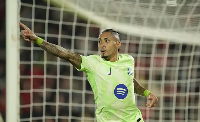 Barcelona's Raphinha celebrates after scoring his side's third goal during a Spanish La Liga soccer match between Mallorca and Barcelona at the Son Moix stadium in Palma de Mallorca, Spain, Tuesday, Dec. 3, 2024. (AP Photo/Jose Breton)