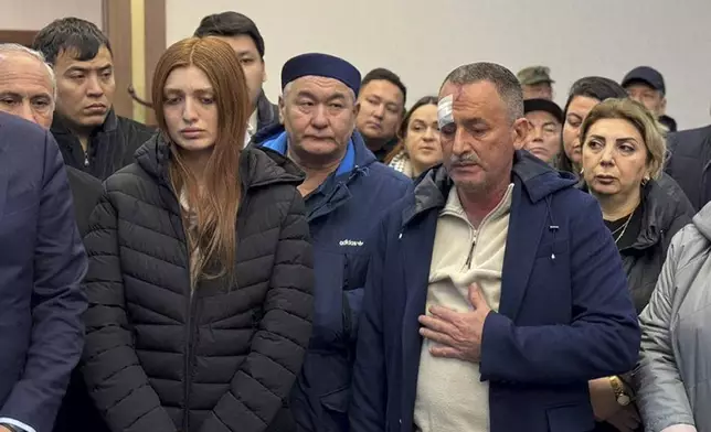 This photo provided by the administration of the Mangystau region of Kazakhstan shows a group of surviving passengers of the crashed Azerbaijan Airlines Embraer 190 prior to departure to Baku at the airport of Aktau, Kazakhstan, on Thursday, Dec. 26, 2024. (Administration of the Mangystau Region via AP)