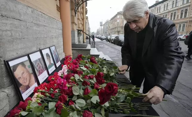 The head of the Azerbaijani diaspora in St. Petersburg Vagif Mamishev lays flowers at the Consulate of Azerbaijan in St. Petersburg, Russia, Thursday, Dec. 26, 2024, in memory of victims of the Azerbaijan Airlines' Embraer 190 that crashed near the Kazakhstan's airport of Aktau. (AP Photo/Dmitri Lovetsky)