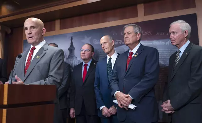 Rep. Keith Self, R-Texas, left, speaks to reporters as he joins a group of conservative Republicans, from left, Rep. Tom Tiffany, R-Wis., Sen. Rick Scott, R-Fla., Rep. Ralph Norman, R-S.C., and Sen. Ron Johnson, R-Wis., to complain about the interim spending bill being crafted to avoid a shutdown of federal agencies, at the Capitol in Washington, Wednesday, Dec. 18, 2024. (AP Photo/J. Scott Applewhite)