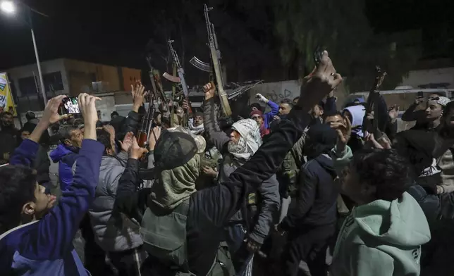 Syrian rebel fighters shout slogans against the late Assad regime in the Mazzeh district in Damascus Wednesday Dec. 25, 2024 (AP Photo/Omar Sanadiki)