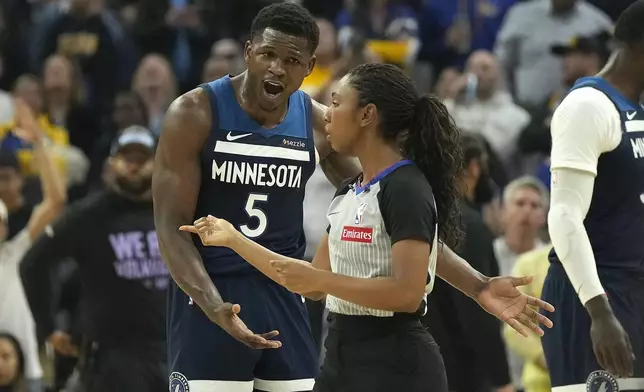 Minnesota Timberwolves guard Anthony Edwards (5) argues with referee Danielle Scott, right, after he received a technical foul during the first half of an NBA basketball game against the Golden State Warriors in San Francisco, Sunday Dec. 8, 2024. (AP Photo/Tony Avelar)