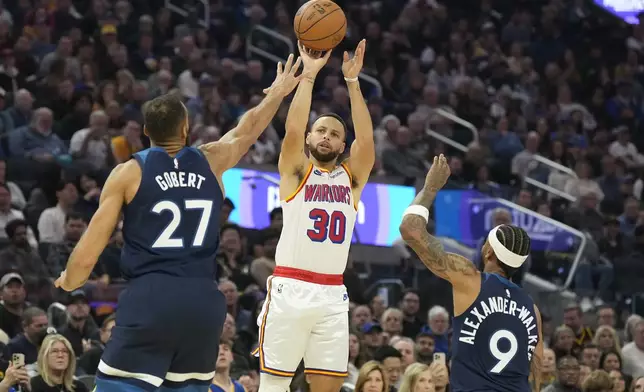 Golden State Warriors guard Stephen Curry (30) takes a 3-point shot over Minnesota Timberwolves center Rudy Gobert (27) and guard Nickeil Alexander-Walker (9) during the first half of an NBA basketball game in San Francisco, Sunday Dec. 8, 2024. (AP Photo/Tony Avelar)