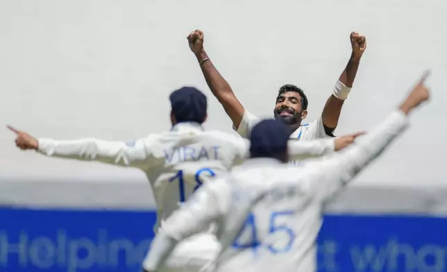 India's Jasprit Bumrah celebrates with teammates after the dismissal of Australia's Travis Head during play on the day four of the fourth cricket test between Australia and India at the Melbourne Cricket Ground, Melbourne, Australia, Sunday, Dec. 29, 2024. (AP Photo/Asanka Brendon Ratnayake)