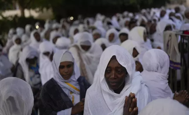 Ethiopian Orthodox Christians pray during celebrations marking St. Gabriel's annual feast, in the West Bank city of Jericho, Saturday, Dec. 28, 2024. (AP Photo/Matias Delacroix)