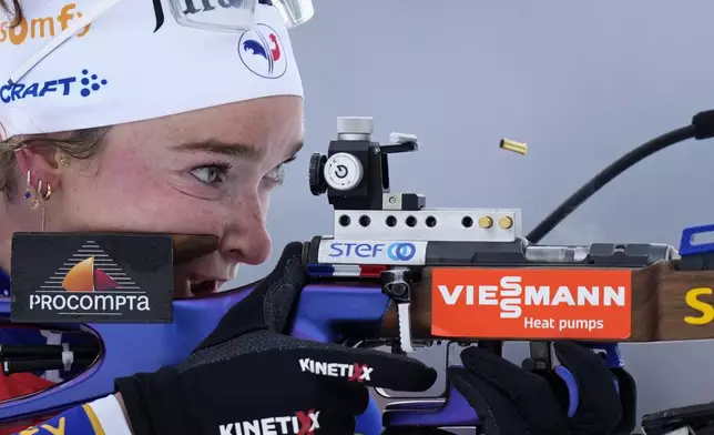 An empty shell casing pops out of the rifle of Lou Jeanmonnot, of France, during the women's 10 km pursuit event at the Biathlon World Cup in Hochfilzen, Austria, Saturday, Dec. 14, 2024. (AP Photo/Matthias Schrader)