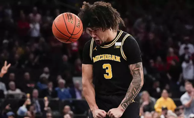 Michigan guard Tre Donaldson (3) reacts during the second half of an NCAA college basketball game against Arkansas, Tuesday, Dec. 10, 2024, in New York. Arkansas won 89-87. (AP Photo/Julia Demaree Nikhinson)