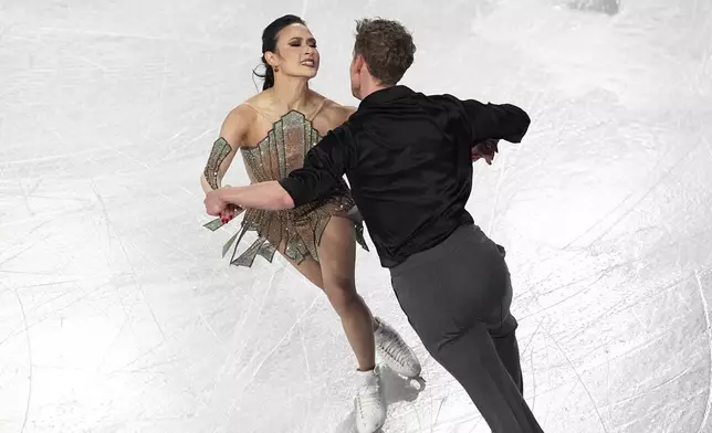 Madison Chock and Evan Bates, of the United States, compete in the ice dance's free dance segment at the ISU Grand Prix Finals of Figure Skating, Saturday, Dec. 7, 2024, in Grenoble, France. (AP Photo/Laurent Cipriani)