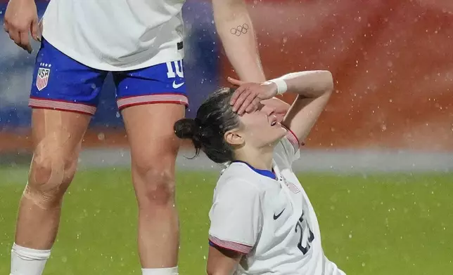 United States' Lindsey Horan, left, checks on teammate Emily Fox after she hurt herself during the international friendly women's soccer match between the Netherlands and the United States at the ADO Den Haag Stadium in The Hague, Netherlands, Tuesday, Dec. 3, 2024. (AP Photo/Peter Dejong)