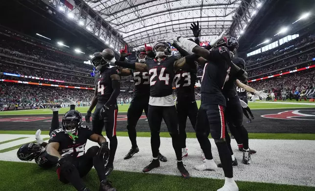 Houston Texans cornerback Derek Stingley Jr. (24) and teammates celebrate his pass interception during the second half of an NFL football game against the Miami Dolphins, Sunday, Dec. 15, 2024, in Houston. (AP Photo/Ashley Landis)