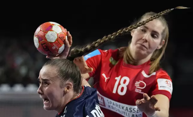 Norway's Thale Rushfeldt Deila, front, tries to score as Denmark's Mette Tranborg defends during the final match of the Women's European Handball Championship between Denmark and Norway, in Vienna, Austria, Sunday, Dec. 15, 2024. (AP Photo/Petr David Josek)