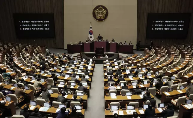 Lawmakers participate in the plenary session at the National Assembly in Seoul, South Korea, Thursday, Dec. 26, 2024. (AP Photo/Ahn Young-joon)