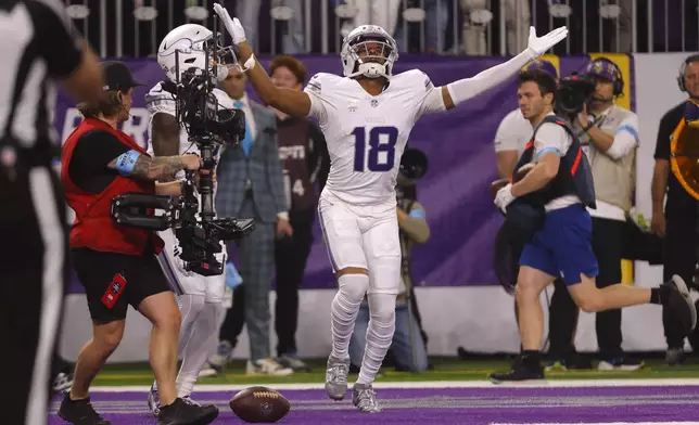 Minnesota Vikings wide receiver Justin Jefferson (18) celebrates after catching a 7-yard touchdown pass during the first half of an NFL football game against the Chicago Bears, Monday, Dec. 16, 2024, in Minneapolis. (AP Photo/Bruce Kluckhohn)