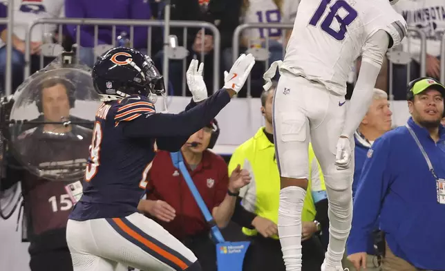 Minnesota Vikings wide receiver Justin Jefferson (18) reaches for an incomplete pass over Chicago Bears cornerback Tyrique Stevenson (29) during the second half of an NFL football game, Monday, Dec. 16, 2024, in Minneapolis. (AP Photo/Bruce Kluckhohn)