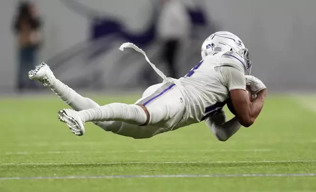 Minnesota Vikings wide receiver Justin Jefferson catches a pass for a first down during the second half of an NFL football game against the Chicago Bears, Monday, Dec. 16, 2024, in Minneapolis. (AP Photo/Abbie Parr)