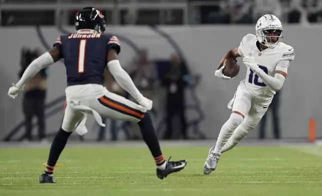 Minnesota Vikings wide receiver Justin Jefferson (18) runs from Chicago Bears cornerback Jaylon Johnson (1) during the first half of an NFL football game, Monday, Dec. 16, 2024, in Minneapolis. (AP Photo/Abbie Parr)