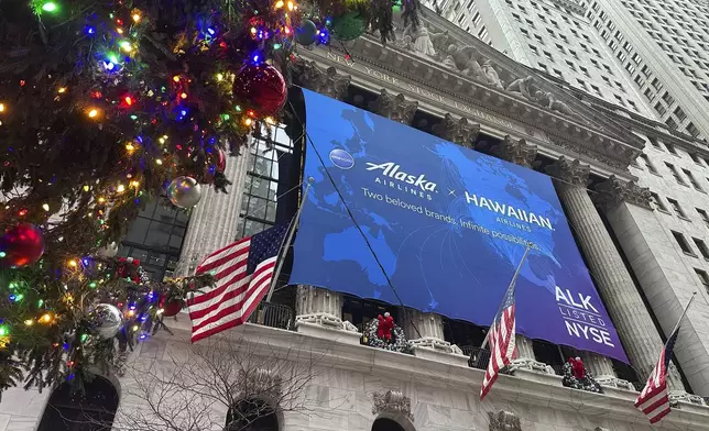 A banner for Alaska Air Group hangs on the front of the New York Stock Exchange in New York's Financial District on Tuesday, Dec. 10, 2024. (AP Photo/Peter Morgan, File)