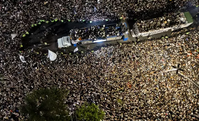 Players of Brazil's Botafogo parade through the streets on a truck during a homecoming celebration after winning the Copa Libertadores soccer tournament, in Rio de Janeiro, Sunday, Dec. 1, 2024. (AP Photo/Bruna Prado)